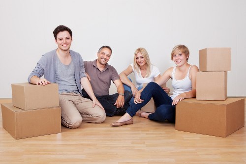 Professional movers carrying items from a Blackheath flat